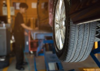 Technician is inflate car tire - car maintenance service transportation safety concept
